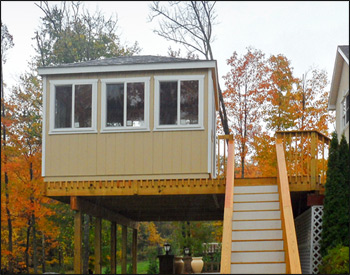  10 x 12 Dura-Temp Rectangle Cabana shown with Leola Almond Paint, White Trim, Plywood Floor, Eight 40" x 46" Horizontal Sliding Window, Standard Single Door, No Shutters, and Rustic Black Asphalt Shingles, Customers sliding glass door and smaller window.