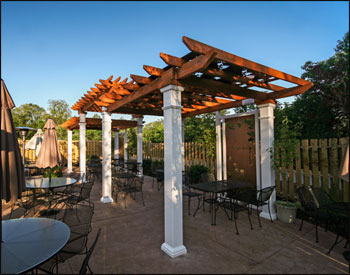 Our Custom Tiered 10’ x 30 Cedar Oasis Pergola is featured above with Grapevine Top Shade Panels, Two Custom Grapevine Privacy Panels, and Cedar Stain/Sealer.