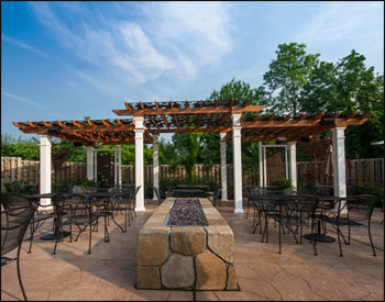 Our Custom Tiered 10’ x 30 Cedar Oasis Pergola is featured above with Grapevine Top Shade Panels, Two Custom Grapevine Privacy Panels, and Cedar Stain/Sealer.
