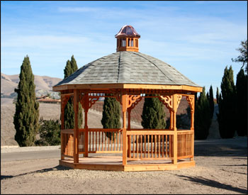 12 Cedar Octagon Belle Roof Gazebo shown with Red Cedar Deck,  2 x 2 Decorative Spindle Railings, Decorative Posts, Decorative Braces, Cupola, Top Railing Sections, Old English Pewter Asphalt Shingles, Clear Stain/Sealer and 4 x 4 Runners