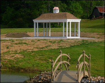 12 x 24 Vinyl Elongated Hexagon Belle Gazebo shown with Rustic Cedar Asphalt Shingles, Cupola with Copper Top, and Electrical Package. 