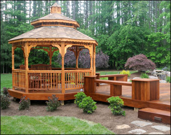 12 Cedar Double Roof Octagon Gazebo shown with Rustic Cedar Asphalt Shingles and Optional Decorative Posts, Turned 2x2 Spindle Railings, Custom Decking and Cedar Tone Stain Sealer.