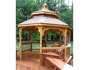 12 Cedar Double Roof Octagon Gazebo shown with Rustic Cedar Asphalt Shingles and Optional Decorative Posts, Turned 2x2 Spindle Railings, Custom Decking and Cedar Tone Stain Sealer.