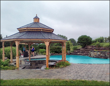 16 Cedar Octagon Double Roof Gazebo shown with no deck, no railings, straight posts, standard braces, no top railings, straight fascia, cupola, cedar tongue and groove ceiling, unstained, midnight gray rubber slate shingles, and hidden wiring w/ 1 receptacle & switch.