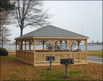 16 x 20 Treated Pine Rectangular Gazebo shown with Treated Pine Deck, 1x3 Standard Railings, Standard Braces, No Cupola, Old English Asphalt Shingles, 17 Bench Sections, and ADA Accesible Handicap Ramp. 