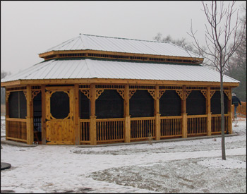 20’ x 36’ Cedar Double Roof Oval Gazebo shown Optional 2x2 Turned Spindle Railings, Decorative Braces, 4 Track Window System, Evergreen Metal Roof and Cedar Tone Stain Sealer.