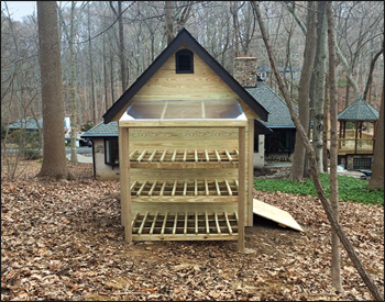 Custom 8 x 10 Deluxe Estate Shed shown with Heavy Duty Pressure Treated Floor, 56" Wood Double Door with Sill Protector, No Windows, Pair of Aluminum Vents, Black Asphalt Shingles, 4x4 Runners, Brown Azek Trim, 12/12 Roof Pitch.