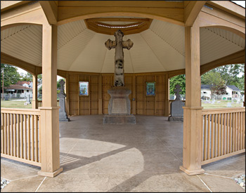 Custom 30 Treated Pine Oval Double Roof Gazebo shown with 42" Tall Railings with 3 Additional Openings, 10" Tall Posts, Arched Beams, Vinyl Finished Ceiling, Harvest Gold Asphalt Shingles, 8/12 Pitch Roof, 3 Full Wall Privacy Walls, Custom Portico, and Custom Fiberglass Cupola.