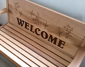 Personalized Text shown on an unstained Cedar Bench. 