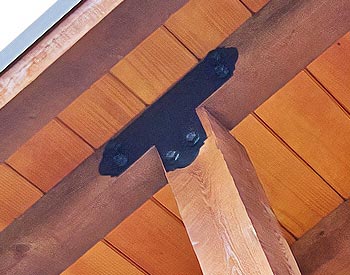 Decorative T-Plate shown connecting a gable spoke and roof beam
