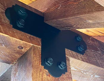 Decorative T-Plate shown connecting a post and beam
