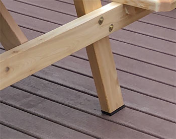 Resin Foot Pads shown on a Cedar Picnic Table.