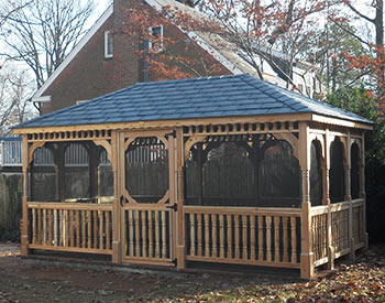 10 x 16 Cedar Rectangular Gazebo shown with No Deck, 2x3 Decorative Spindle Rails, Decorative Posts, Standard Braces, Full Set of Screens and Screen Door, Midnight Grey Rubber Slate Shingles, and Additional Door. 