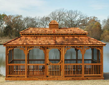  10 x 20 Cedar Rectangular Double Roof Gazebo shown with Cedar Deck, Cupola, Wavy Fascia, Cedar Shake Shingles, Full Set of Screens & Screen Door, Cedar Stain, and 1 Extra Door. 